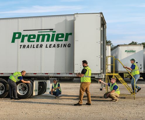 Premier employees inspecting a truck before deployment
